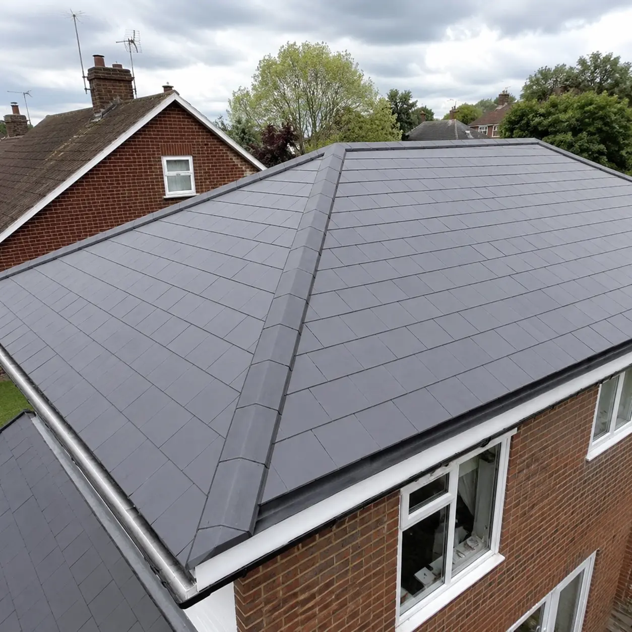 New grey tiled hipped roof completed in Crawley & Horsham