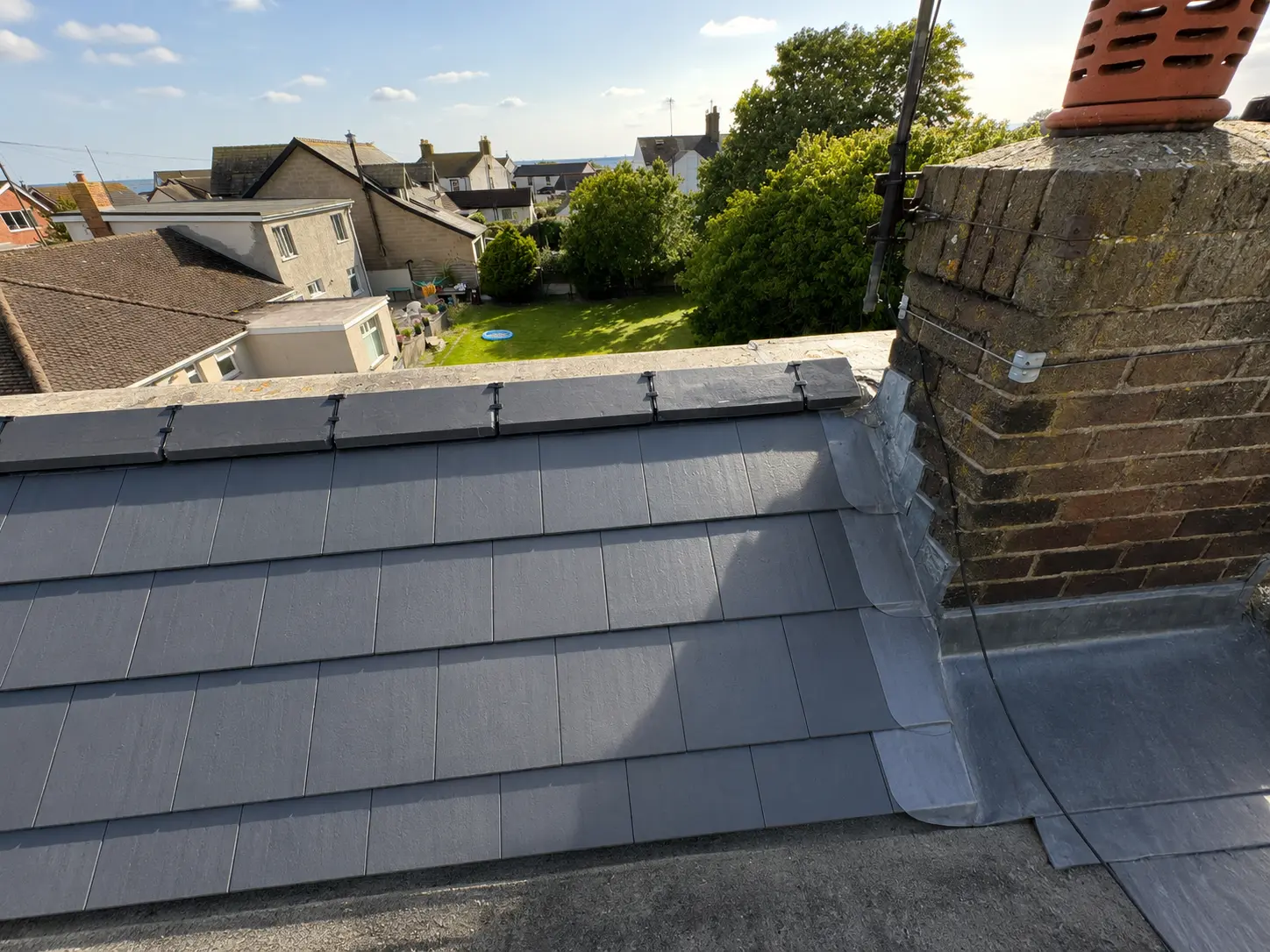 Slate roof with new lead flashing around a chimney